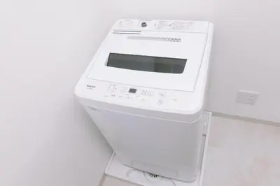 a white microwave sitting on top of a wall at 8min walk from Shibuya Sta Universal design in Tokyo