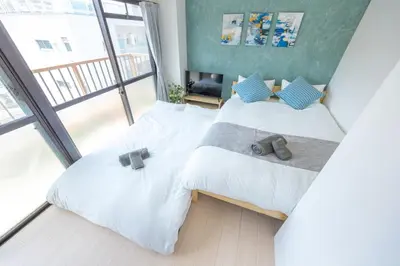 a bedroom with two beds with shoes on them at Kinshicho First Rooftop in Tokyo