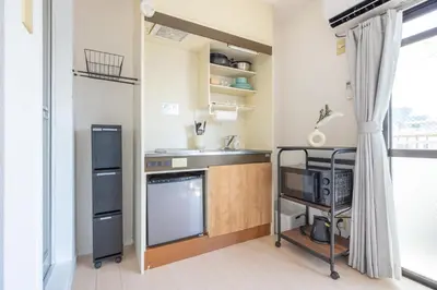 a small kitchen with a sink and a counter at Kinshicho First Rooftop in Tokyo