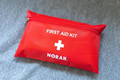 a red pillow with the first aid kit on it at Kinshicho First Rooftop in Tokyo
