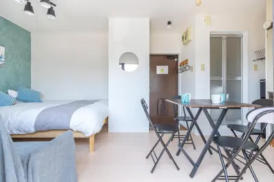 a bedroom with a bed and a table and chairs at Kinshicho First Rooftop in Tokyo