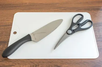 a pair of scissors sitting on top of a cutting board at Kinshicho First Rooftop in Tokyo