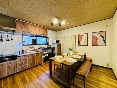 a kitchen with a table and a dining room at Poco Land in Tokyo