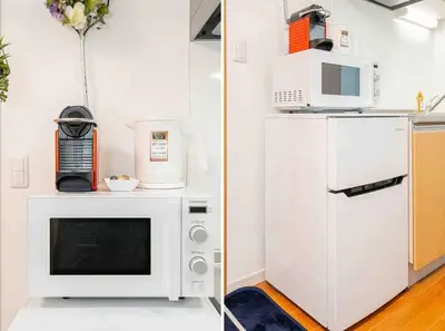 a kitchen with a microwave and a refrigerator at Akihabara Skytree Premium Apartment 102 in Tokyo
