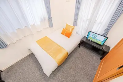 a bedroom with a bed and a television on a table at Akihabara Skytree Premium Apartment 102 in Tokyo