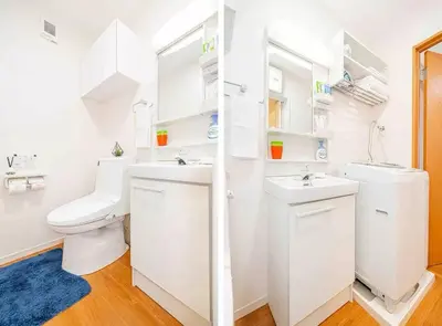 a white bathroom with two sinks and a toilet at Akihabara Skytree Premium Apartment 102 in Tokyo