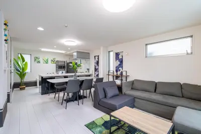 a living room with a couch and a table at Conveniently located 10 min walk from Shin-Okubo Station and 7 min walk from Higashi-Shinjuku Station -Okubo hosuse- in Tokyo