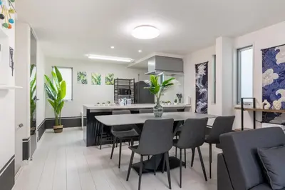 a kitchen and dining room with a table and chairs at Conveniently located 10 min walk from Shin-Okubo Station and 7 min walk from Higashi-Shinjuku Station -Okubo hosuse- in Tokyo