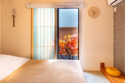 a bedroom with a bed and a window and a clock at \u5922\u306e\u5bbf\u5f69\u308a 127t in Tokyo