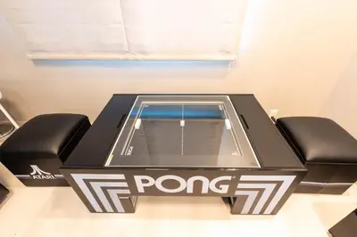 a ping pong table with two black chairs at \u5922\u306e\u5bbf\u5f69\u308a 127t in Tokyo