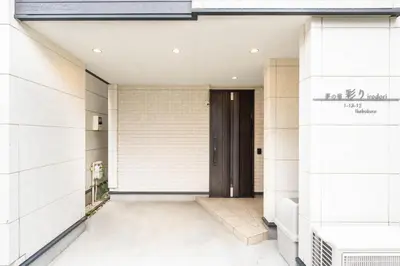 a entrance to a building with a black door at \u5922\u306e\u5bbf\u5f69\u308a 127t in Tokyo