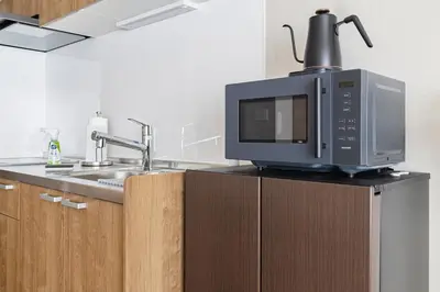 a microwave sitting on top of a kitchen counter at 365Ueno in Tokyo