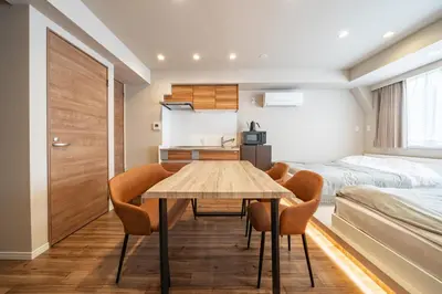 a room with a table and chairs and a bedroom at 365Ueno in Tokyo