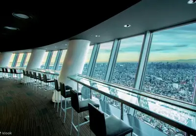 a row of chairs in a building with a city view at Poco Inn in Tokyo