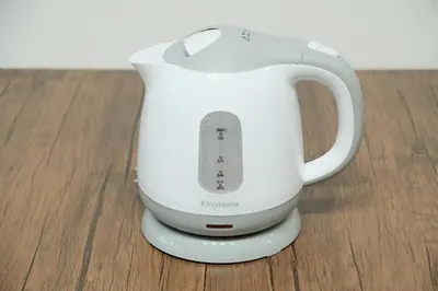 a white blender sitting on top of a wooden floor at Poco Inn in Tokyo