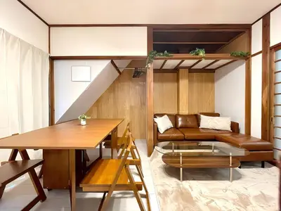 a living room with a couch and a table at Poco Inn in Tokyo