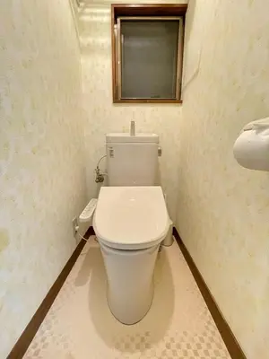 a white toilet in a bathroom with a window at Poco Inn in Tokyo