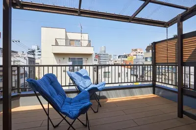a blue chair sitting on top of a balcony at HeySky Oshiage in Tokyo