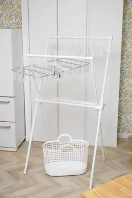 a glass shelf on a white stand next to a basket at HeySky Oshiage in Tokyo
