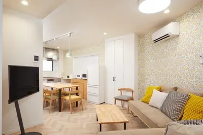 a living room with a couch and a table at HeySky Oshiage in Tokyo