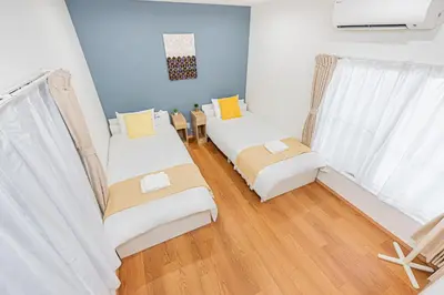 a room with two beds and a window at Mori House \u795e\u697d\u5742 in Tokyo