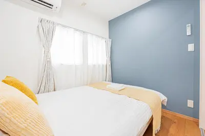 a bedroom with a bed and a window at Mori House \u795e\u697d\u5742 in Tokyo