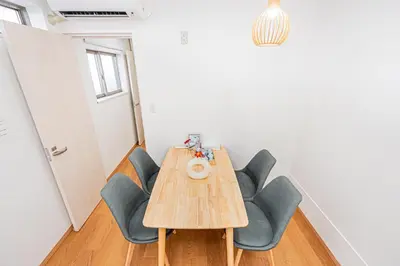 a dining room with a wooden table and chairs at Mori House \u795e\u697d\u5742 in Tokyo