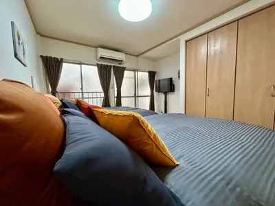 a bedroom with a large bed with pillows on it at Tokyo Love House 2 in Tokyo