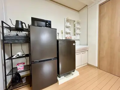 a kitchen with a stainless steel refrigerator in a room at Tokyo Love House 2 in Tokyo