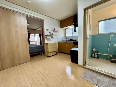 a bathroom with a door open to a kitchen at Tokyo Love House 2 in Tokyo