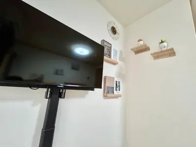 a flat screen tv hanging on a wall at Tokyo Love House 2 in Tokyo