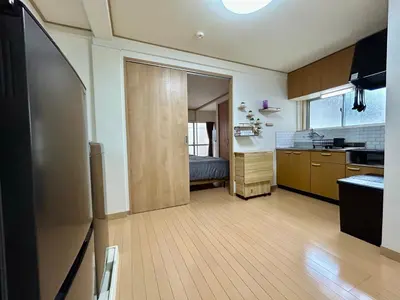 a kitchen with wooden floors and a room with a sink at Tokyo Love House 2 in Tokyo