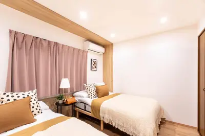 a bedroom with two beds and a window at \u78a7\u685c 126t in Tokyo