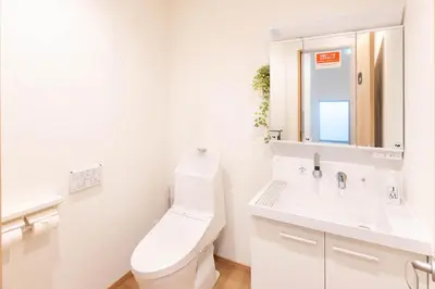 a white bathroom with a toilet and a sink at \u78a7\u685c 126t in Tokyo