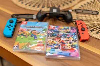 two video games and controllers sitting on a table at \u78a7\u685c 126t in Tokyo