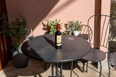 a bottle of wine sitting on a table with two glasses at \u78a7\u685c 126t in Tokyo