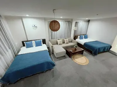 a hotel room with two beds and a couch at Yamanote Line to Shinjuku or Shibuya in Tokyo