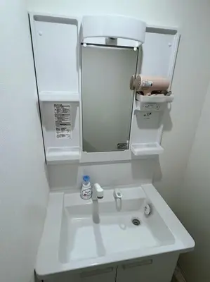 a bathroom with a white sink and a mirror at Yamanote Line to Shinjuku or Shibuya in Tokyo