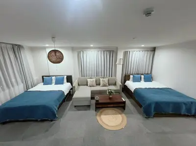 a room with two beds and a couch in it at Yamanote Line to Shinjuku or Shibuya in Tokyo