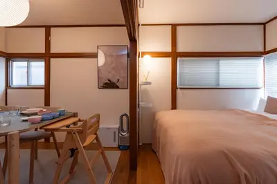 a bedroom with a bed and a desk and a table at Homie Hiroo in Tokyo