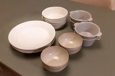 a group of white plates and bowls on a table at Homie Hiroo in Tokyo