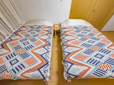 two beds sitting next to each other in a room at Skytree STAR 11 Hotel in Tokyo