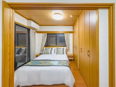 a bed in a small room with a window at Skytree STAR 11 Hotel in Tokyo