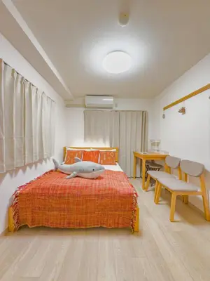 a bedroom with a bed and a table and a desk at Skytree STAR 11 Hotel in Tokyo