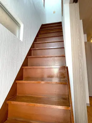 a staircase in a house with wood steps at Shibamata house self check in in Tokyo
