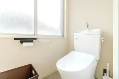 a white toilet in a bathroom with a window at Racto Hotel Higashijujo \u697d\u9014\u30db\u30c6\u30eb \u6771\u5341\u6761 in Tokyo