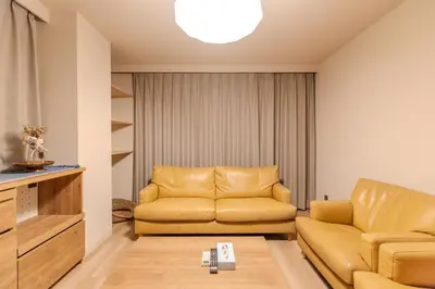 a living room with a couch and a table at Racto Hotel Higashijujo \u697d\u9014\u30db\u30c6\u30eb \u6771\u5341\u6761 in Tokyo