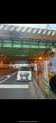 a white car is parked under a tunnel at \u6771\u65b9\u306e\u6e2f\u6e7e25\u5e73\u65b9\u5927\u5e8a\u623f203Oriental Harbor 25 square meter king size bed room203 in Tokyo