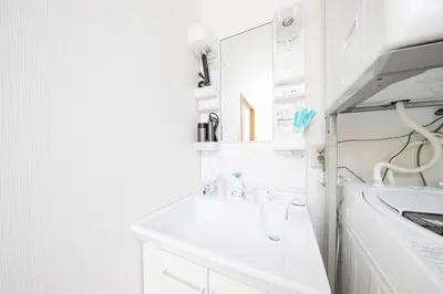 a white bathroom with a sink and a mirror at Japan Tokyo Ueno Ikebukuro private house 5Ppl 3Bed 37m2 for Family in Tokyo
