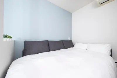 a bedroom with a large white bed in a room at Japan Tokyo Ueno Ikebukuro private house 5Ppl 3Bed 37m2 for Family in Tokyo